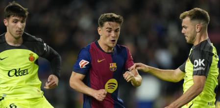 BARCELONA, 22/04/2025.- El centrocampista del Barcelona Gavi (c) trata de jugar un balón entre Valery Fernández (i) y Antonio Lato, ambos del Mallorca, durante el partido de la jornada 33 de LaLiga que FC Barcelona y RCD Mallorca disputan hoy martes en el Estadi Olímpic Lluís Companys. EFE/Alejandro García